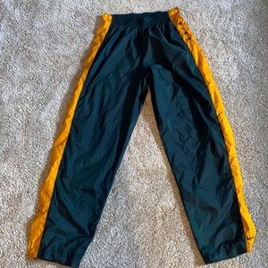Vintage green and yellow Nike tear away track pants.